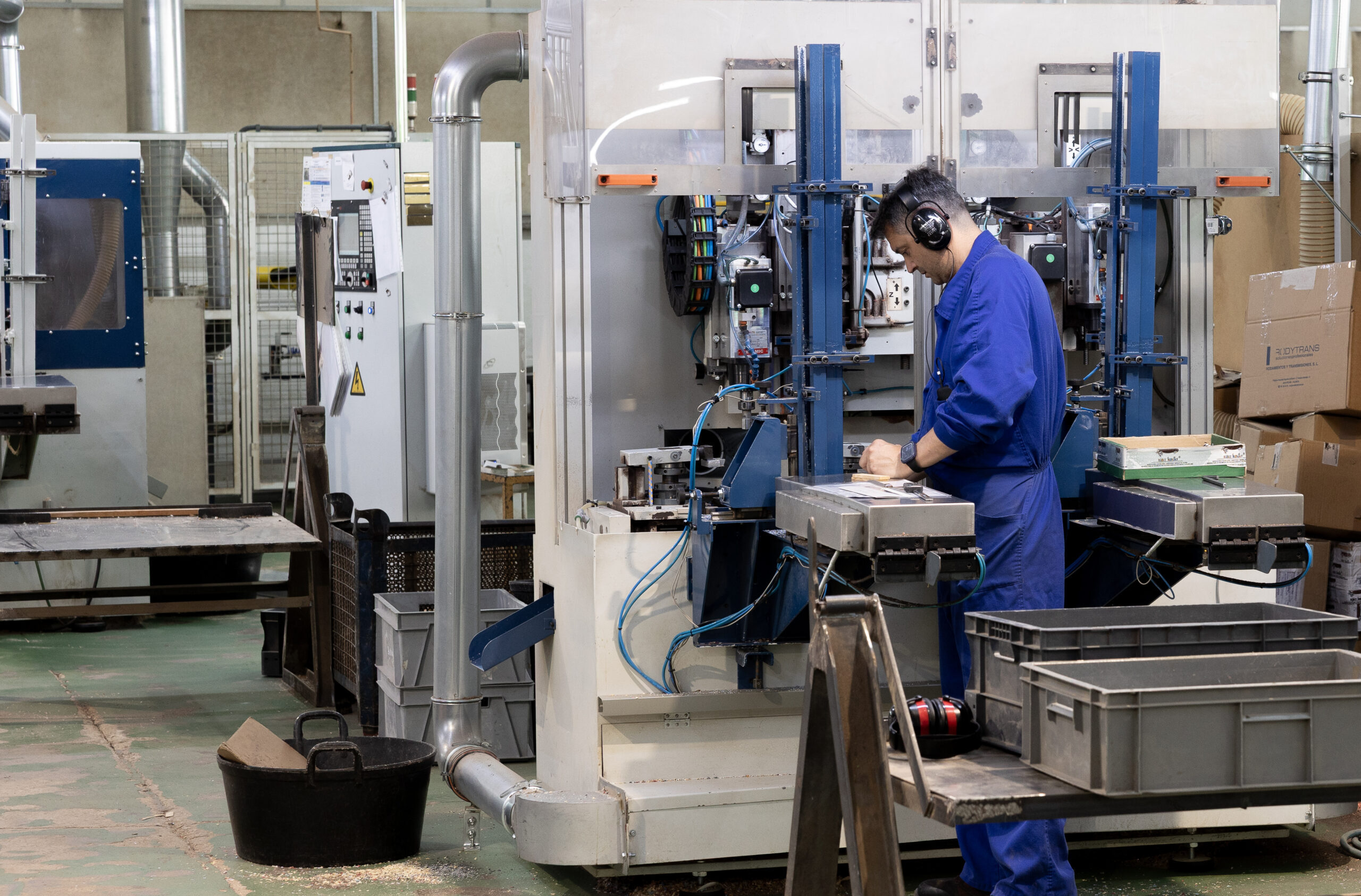 Worker operating a machine at the factory workshop