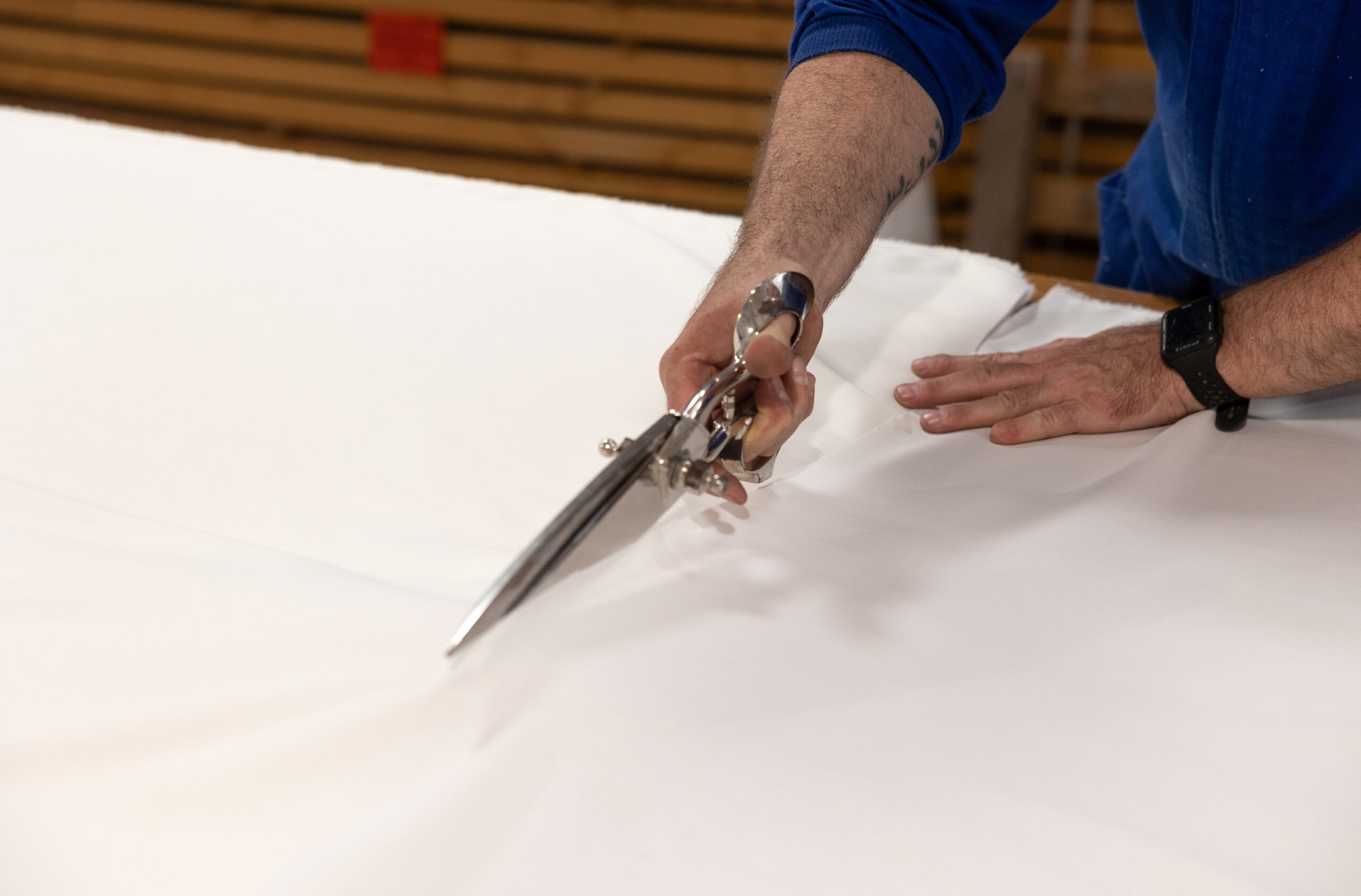 Worker cutting pieces of fabric for mikarta handles